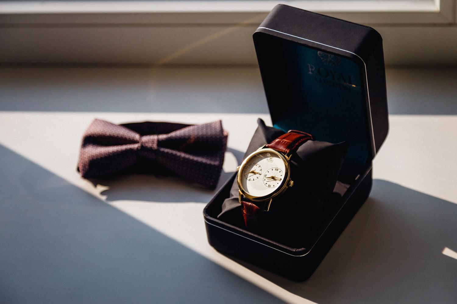 watch-black-box-bow-tie-lie-white-windowsill